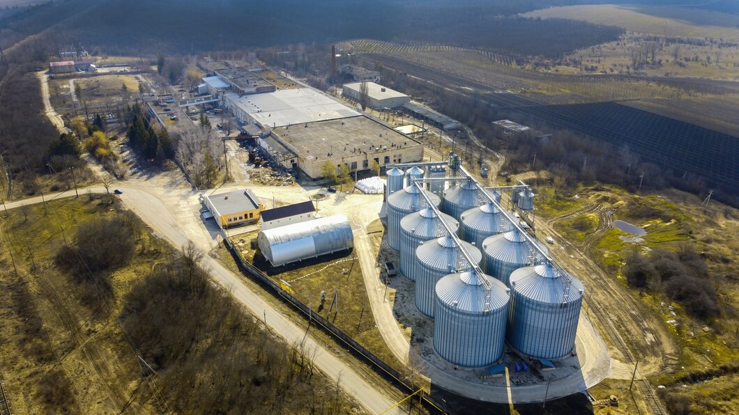 aerial-drone-view-winery-metal-cisterns-with-bare-trees-fields-around-it-moldova_1268-17445